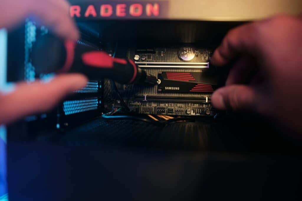 Hand using a screwdriver on a circuit board